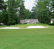 Rose Hill Golf Club's green on No. 18 is guarded by a steep, shaggy bunker.