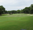 Cotton Dike's No. 18 from the tee lays out bunkers right, trees and marsh left, and many mounds and swales in the fairway.