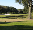 The par-3 14th hole at the Barony Course at Port Royal Golf Club is over water to a green with water on one side, sand on two others.
