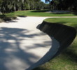 Nearly vertical railroad-tie walls all but surround the elevated green on No. 14 at Harbour Town Golf Links.