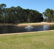 Oyster Reef Golf Club's 11th hole, a par 3, is a short shot over water to a large green.