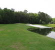 A bunker near the 10th green at Crescent Pointe Golf Club disappears into a pond.