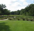 The 15th fairway at Crescent Pointe Golf Club seems tighter than it is because trees come in close.