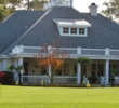 The putting green sits in the shadow of the Golden Bear Golf Club at Indigo Run clubhouse. 