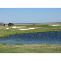 The par-3 13th hole on the Dye course at Colleton River Plantation backs right up to the marsh, with the ocean beyond.