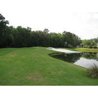 A bunker near the 10th green at Crescent Pointe Golf Club disappears into a pond.